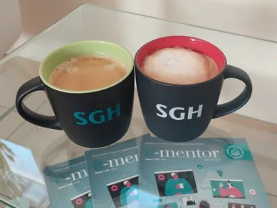 dwa kubki SGH z kawą